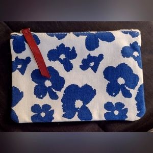 White makeup bag with blue floral print.